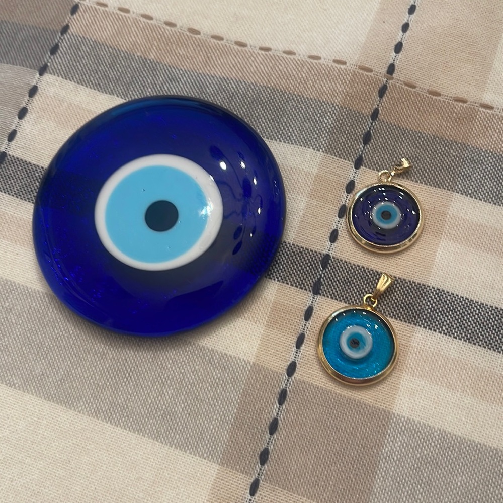 Evil eye charms and handheld bead.